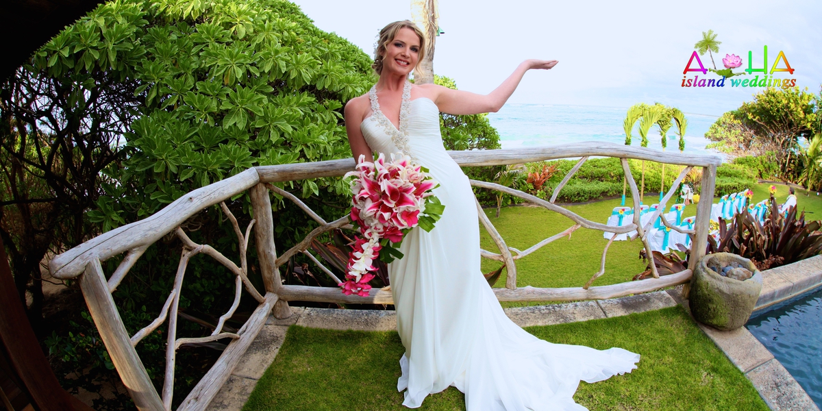 Smiling bride holding a pink bouquet on a rustic wooden bridge in the estate garden